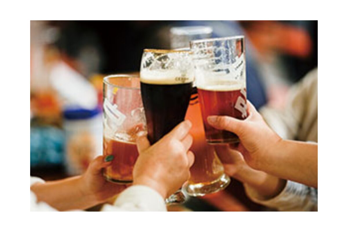 Beer glasses raised in a toast